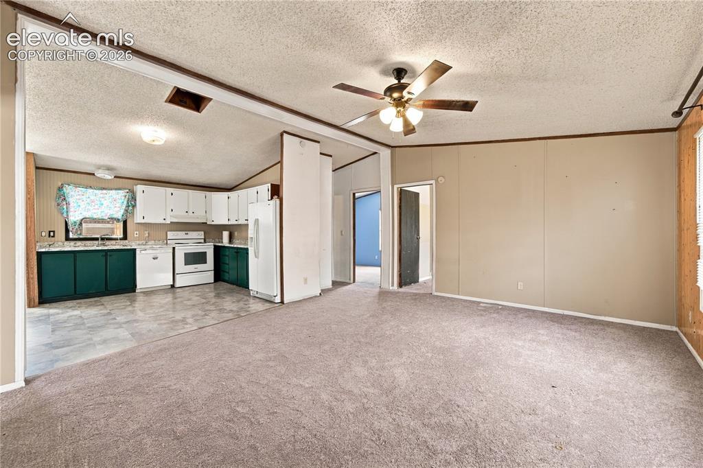 Image 3 of 19: Kitchen with white upper cabinetry, dark green lower cabinetry, and white a