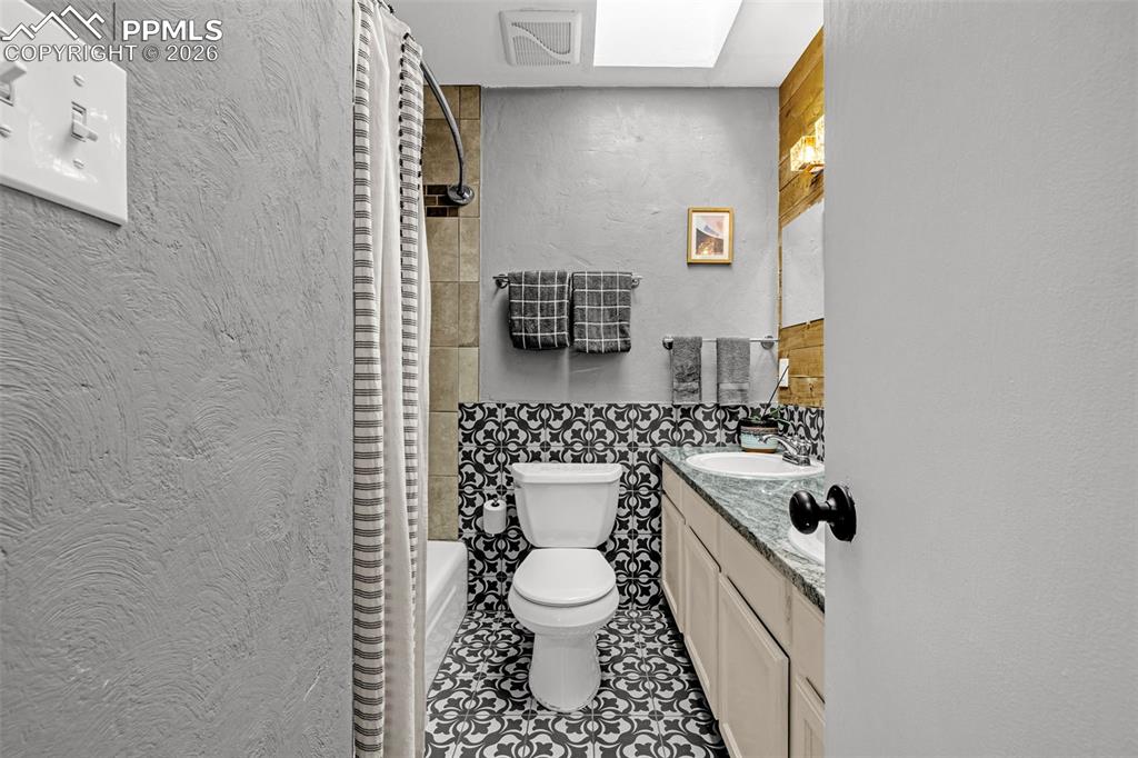 Image 23 of 44: double vanity with skylight