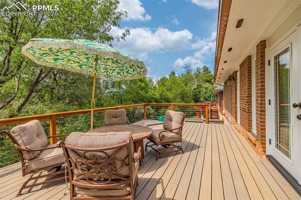 Image 3 of 44: Wooden terrace with outdoor dining space