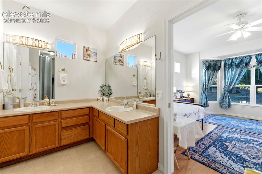 Image 13 of 31: Bathroom featuring dual integrated sinks with chrome faucets, expansive woo