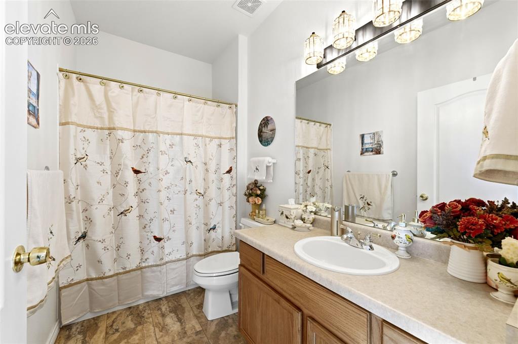 Image 16 of 31: Bathroom featuring a vanity with a laminate countertop, integrated sink, an