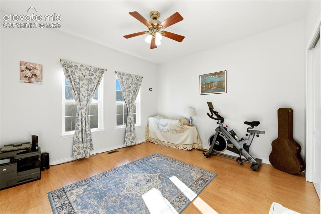 Image 17 of 31: Light-filled interior space featuring two windows, wood-finish flooring, a 
