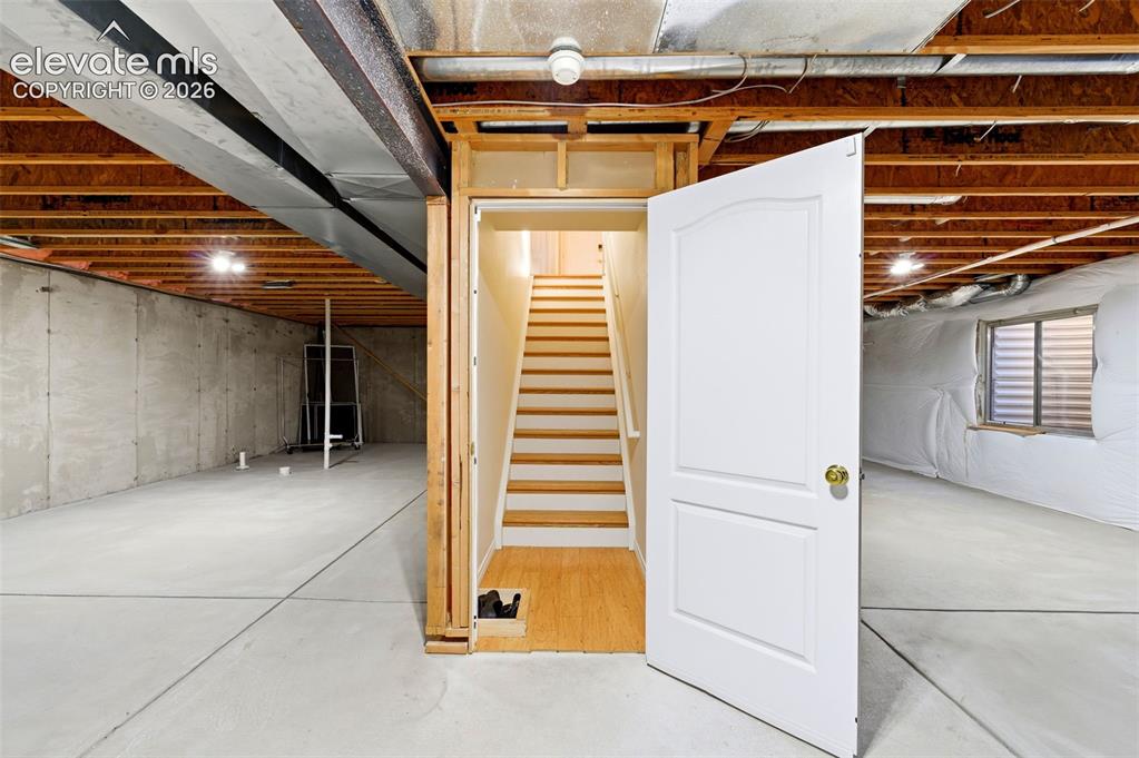 Image 19 of 31: Expansive unfinished basement featuring concrete flooring, exposed wood joi