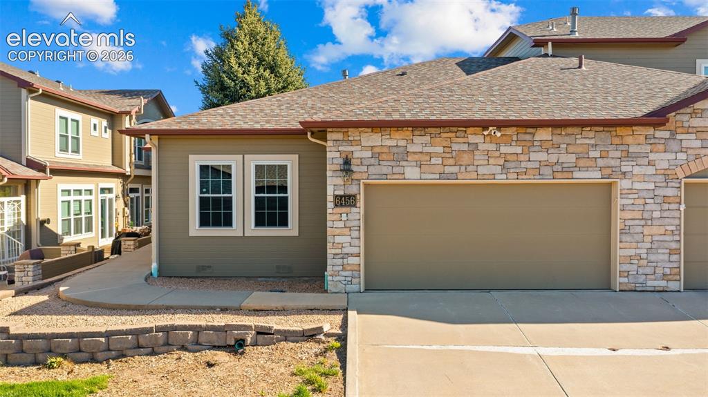 Image 23 of 31: Exterior featuring a stone facade and stucco siding
