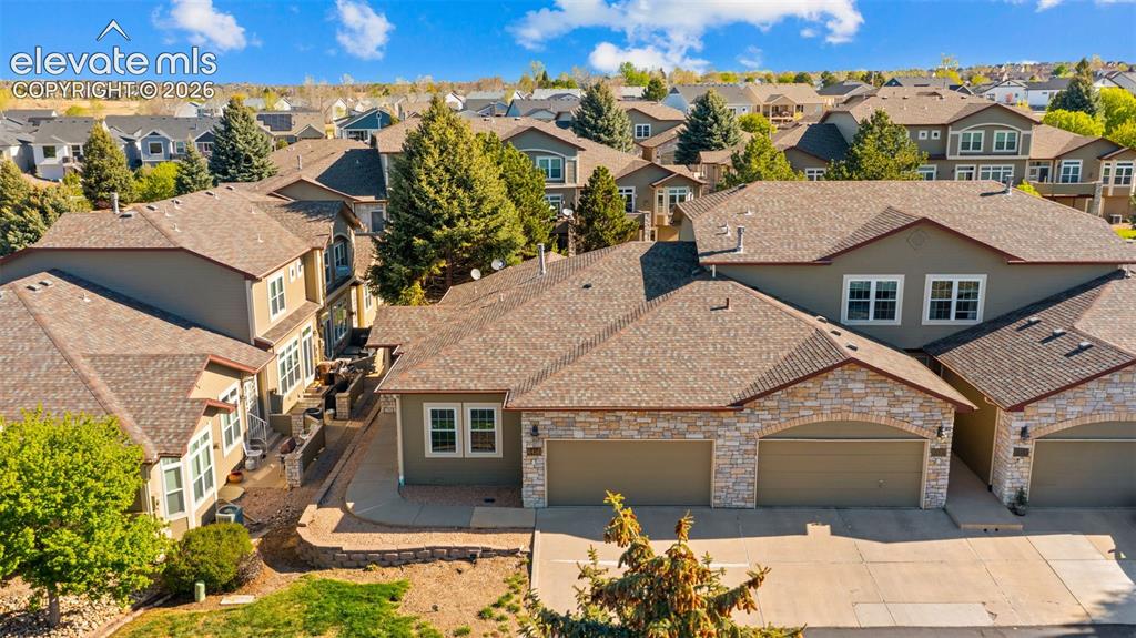 Image 29 of 31: Residential structure featuring a stone and stucco exterior, multi-panel ga