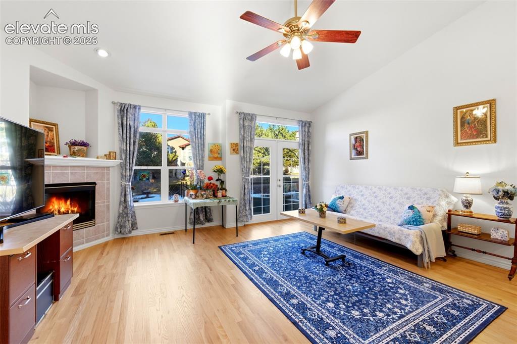 Image 3 of 31: Bright living area featuring vaulted ceilings, light wood-finish flooring, 
