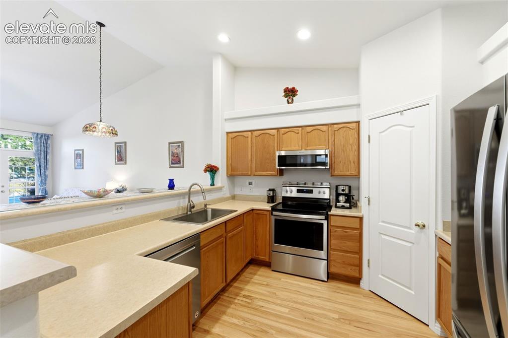 Image 8 of 31: Kitchen featuring wood cabinetry, stainless steel appliances, solid surface
