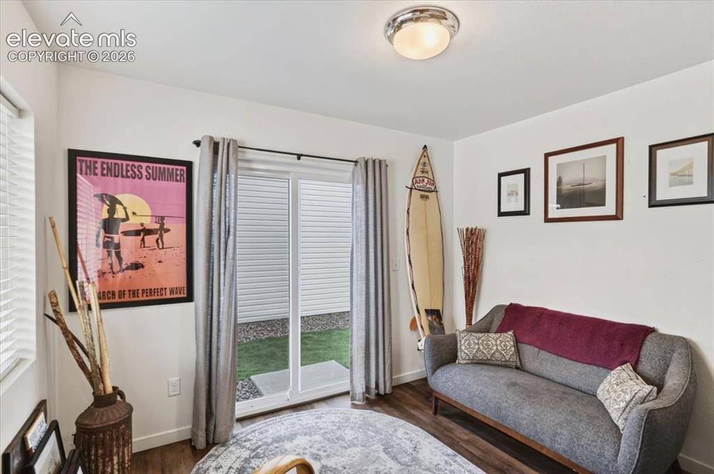 Image 10 of 48: Access to the fenced yard is just steps from the front door and garage.