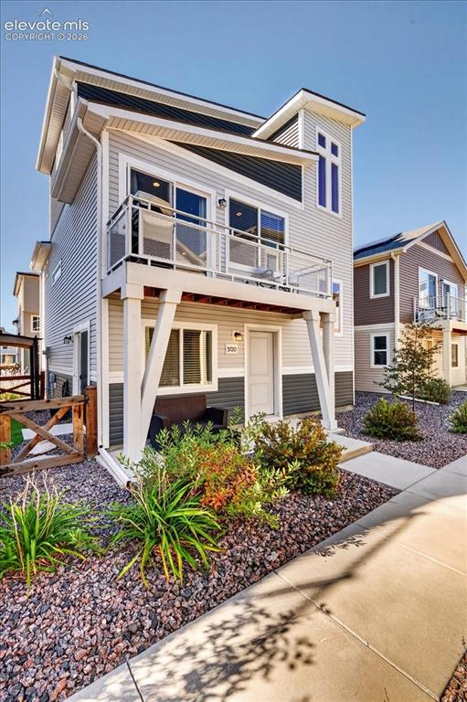 Image 37 of 48: Modern multi-level exterior with light-toned siding and dark accents, featu