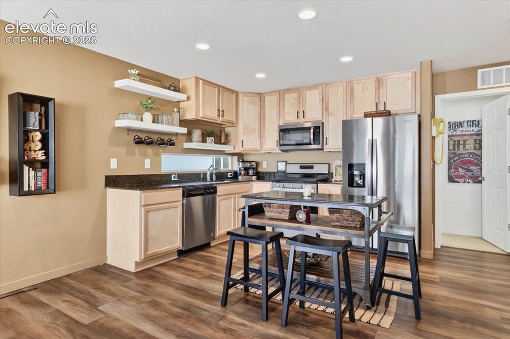 Image 5 of 48: The kitchen is the focal point of the home, featuring a large dining space