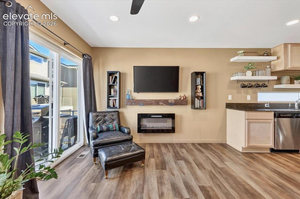 Image 6 of 48: This open and spacious living area has a fireplace and walkout to the balco