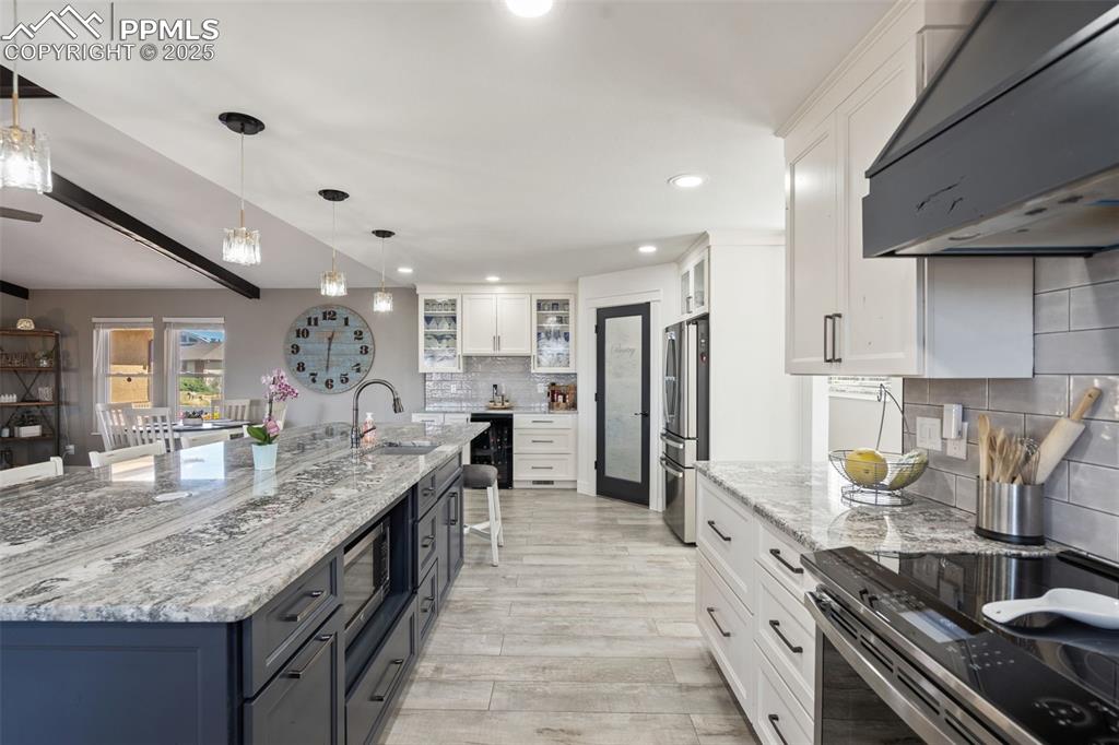 Image 16 of 49: WOW, WOW, WOW!!! This kitchen island has it all: 2nd sink, microwave, pop u