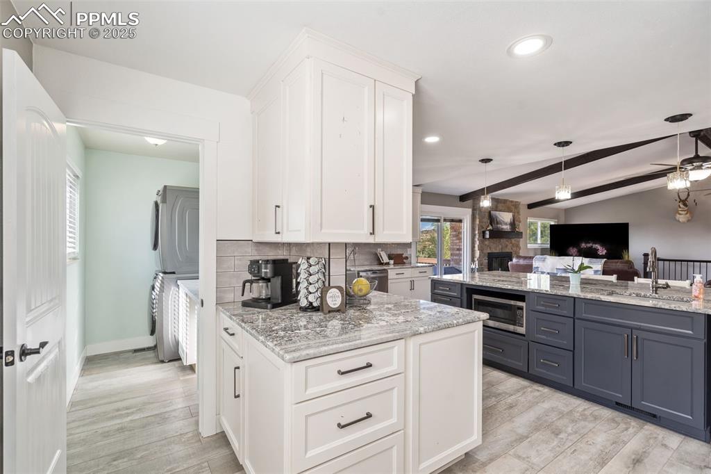 Image 18 of 49: Coffee bar area with more cabinets and check out the microwave in the large