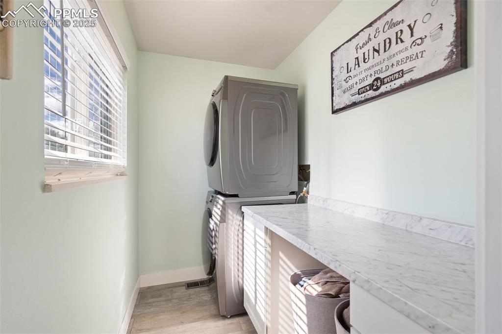 Image 19 of 49: Airy main level laundry room off the kitchen, perfect for a stackable washe