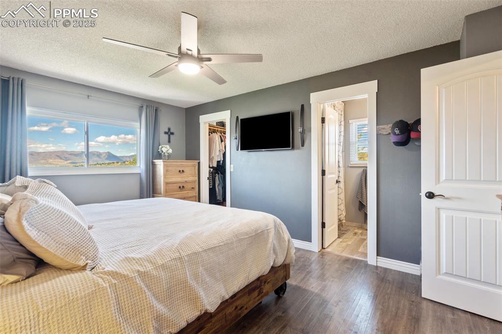 Image 23 of 49: Primary bedroom with a walk-in closet and 3/4 bathroom w/ spa type shower.