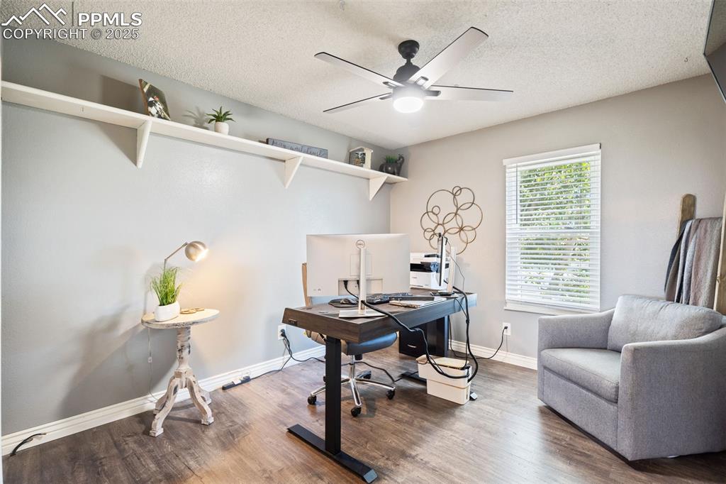 Image 26 of 49: Roomy bedroom on the main level, or make it your home office.