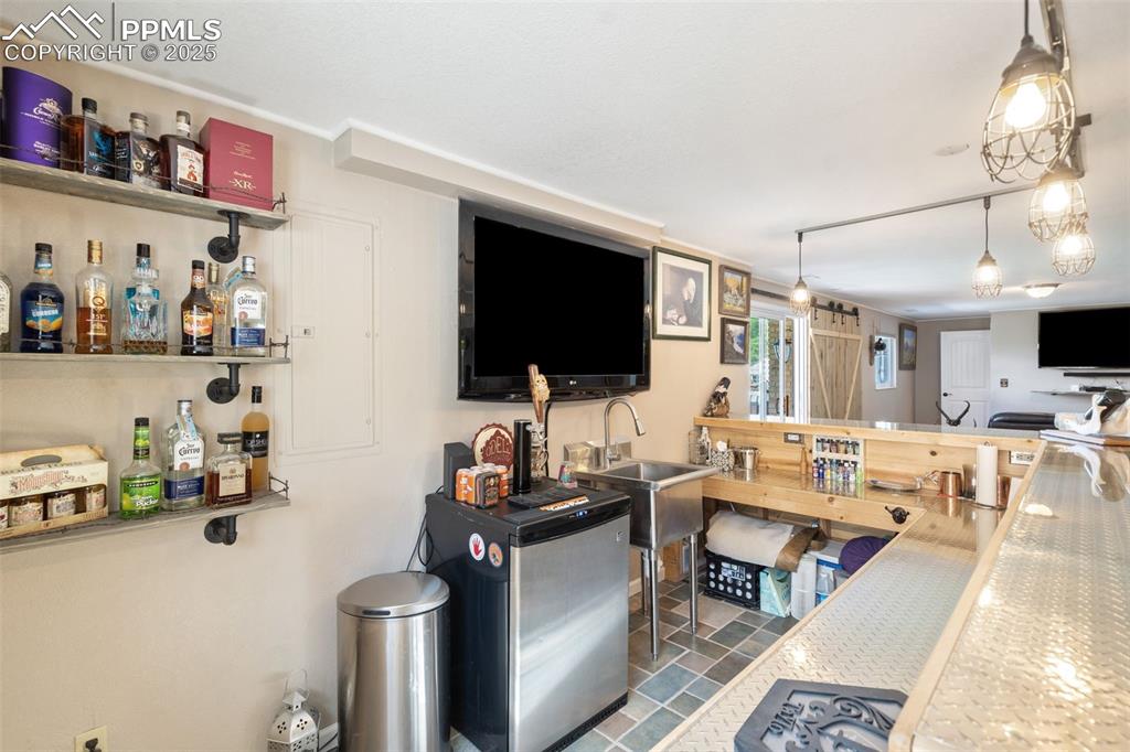 Image 31 of 49: This custom wet bar has all you need for entertaining!