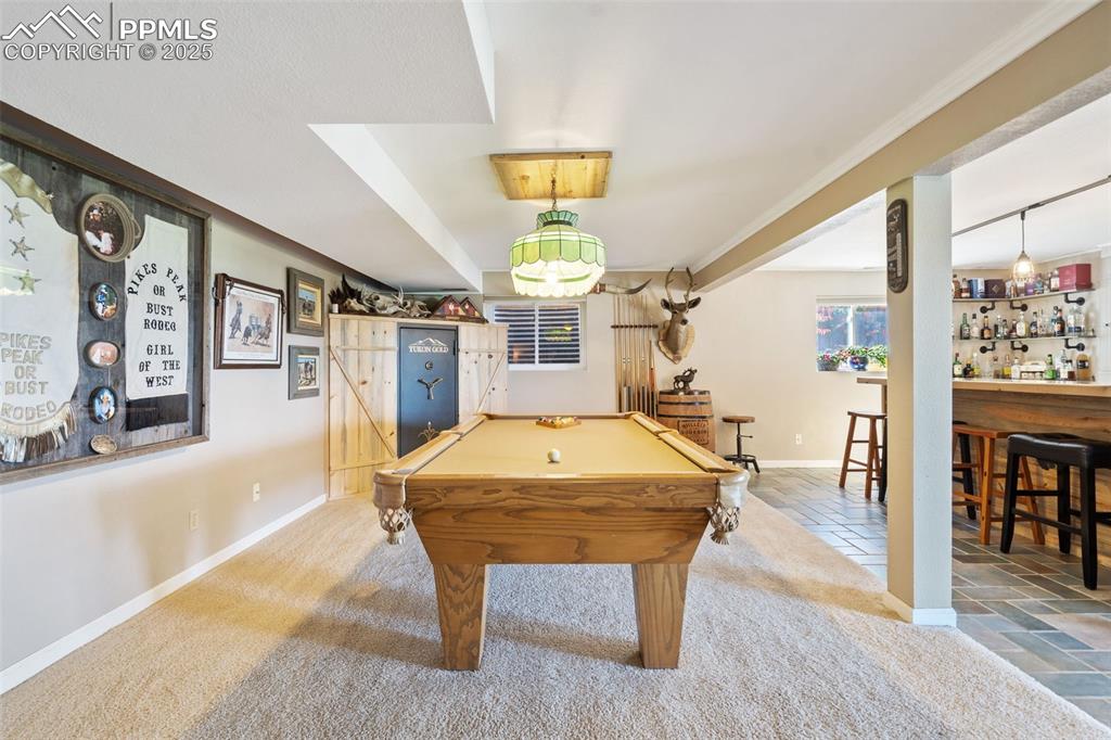 Image 32 of 49: Beautiful pool table compliments this space perfectly! It stays along with 