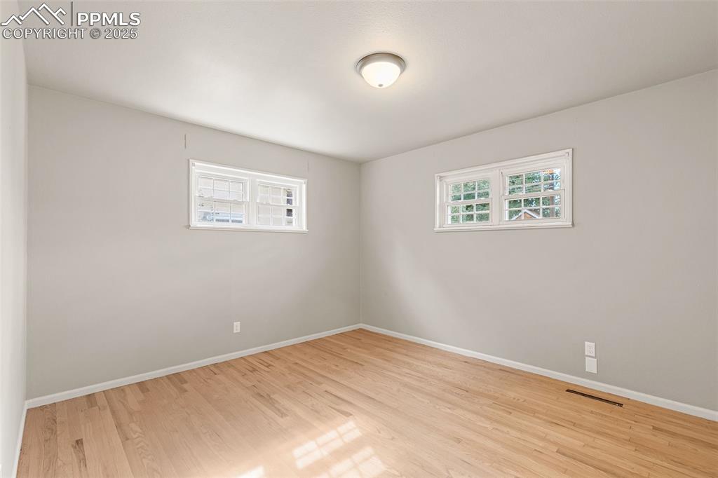 Image 13 of 17: Empty room with light wood-style flooring