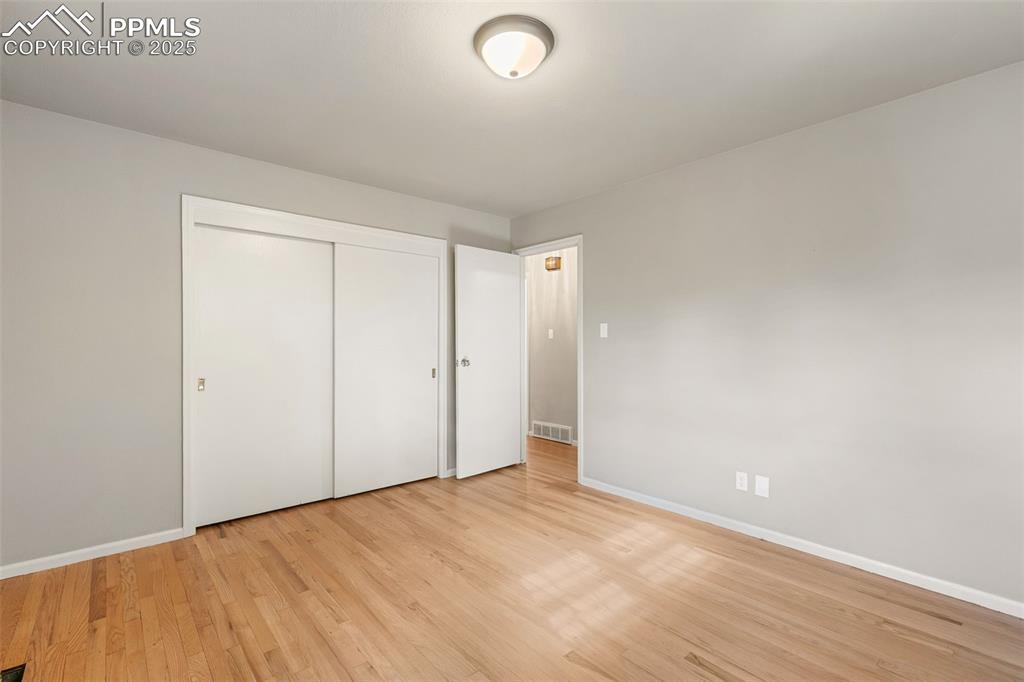 Image 14 of 17: Unfurnished bedroom with a closet and light wood-style floors