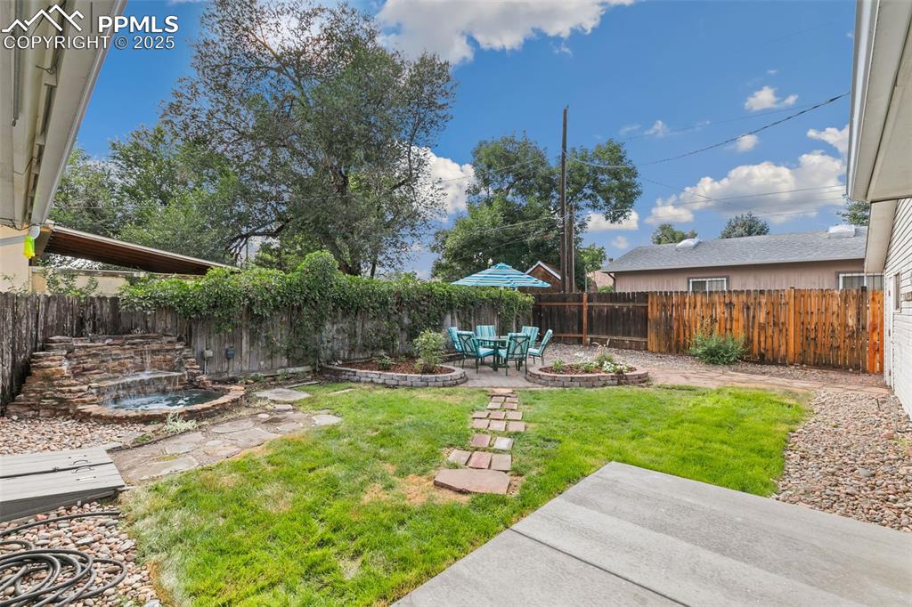Image 16 of 17: Fenced backyard featuring a patio area