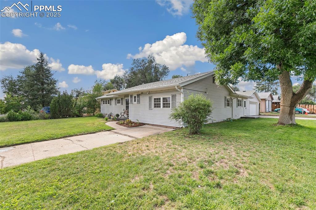 Image 3 of 17: Ranch-style home with a front lawn