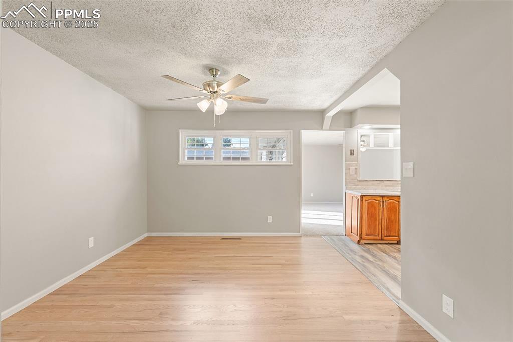 Image 8 of 17: Unfurnished room featuring light wood-style flooring, a textured ceiling, a