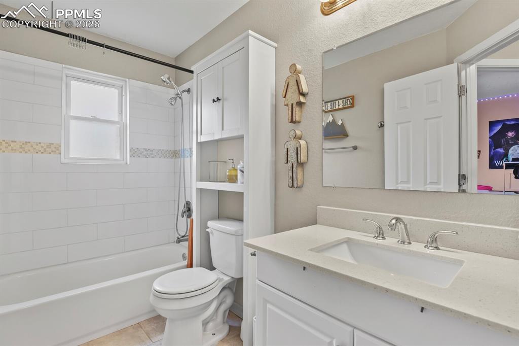 Image 21 of 38: Full bathroom featuring a white vanity,  mirror and a shower with white sub