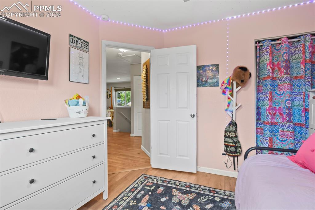 Image 23 of 38: This bedroom features  hardwood flooring