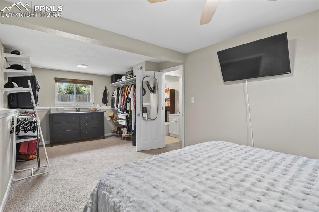 Image 25 of 38: Located on the lower level this primary bedroom features carpeting, nice wi