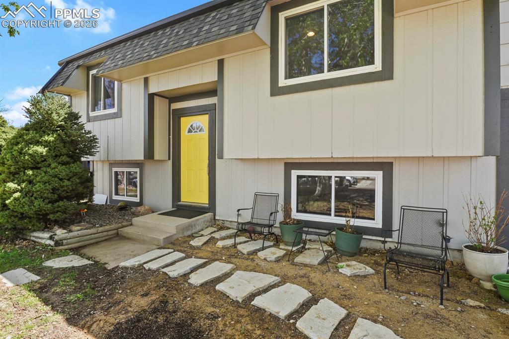 Image 3 of 38: The property features a light-colored exterior with dark trim and a bright 