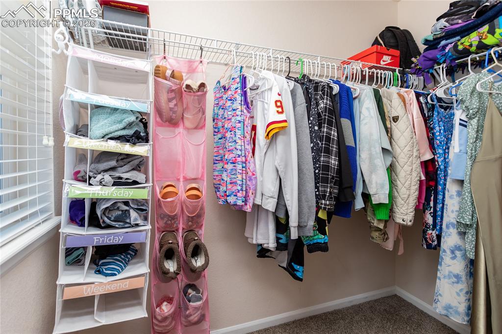 Image 27 of 39: Walk in closet in secondary bedroom
