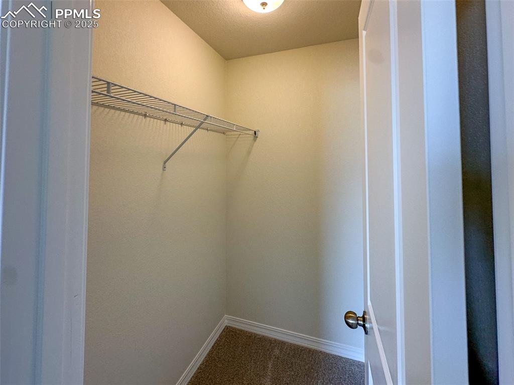 Image 23 of 35: Walk in closet 