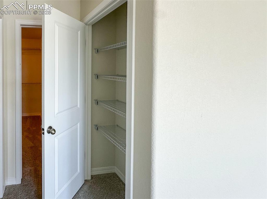 Image 30 of 35: Primary bedroom linen closet 