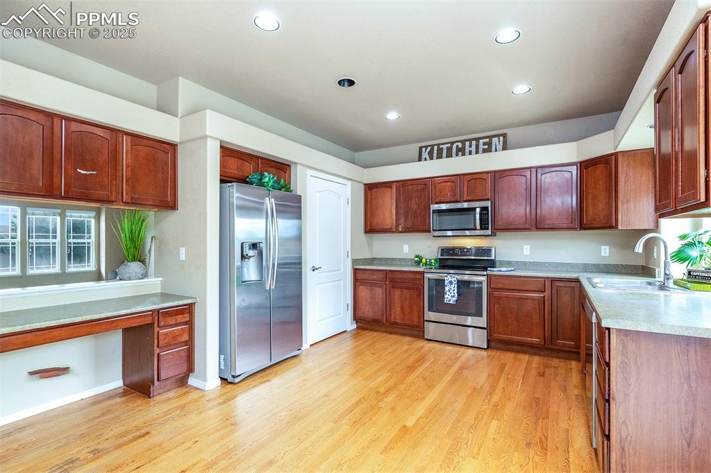 Image 10 of 46: Kitchen featuring stainless steel appliances, light wood-type flooring, rec