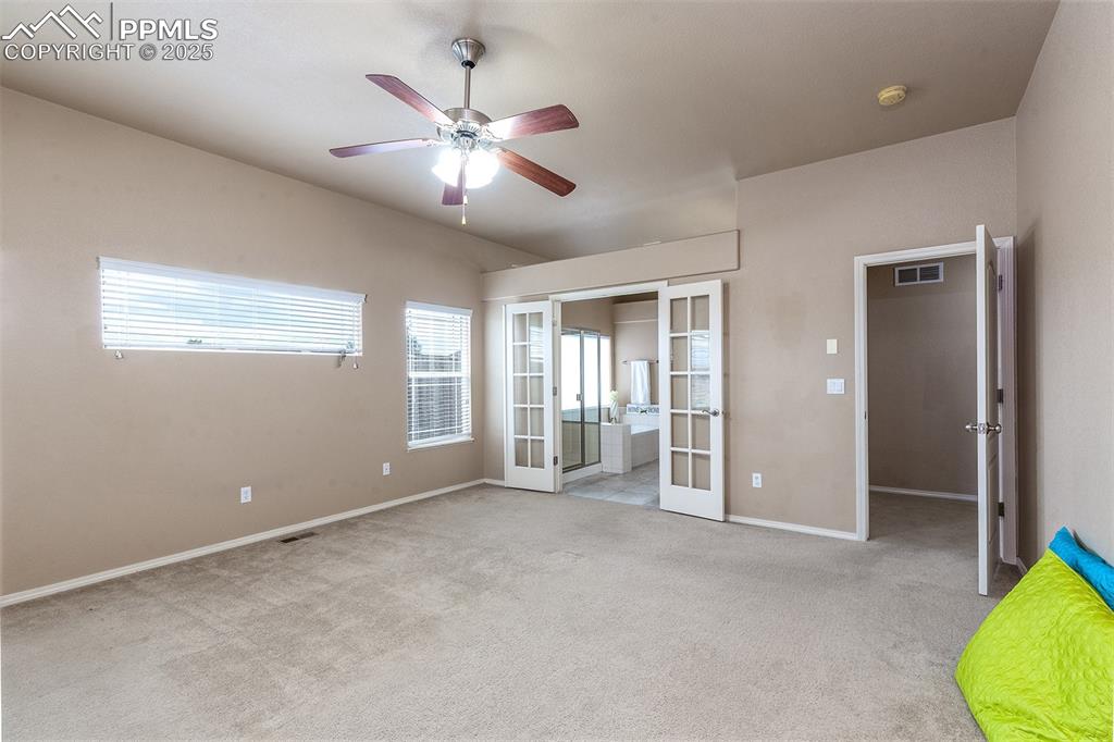 Image 17 of 46: Unfurnished bedroom featuring french doors, carpet flooring, and a ceiling 