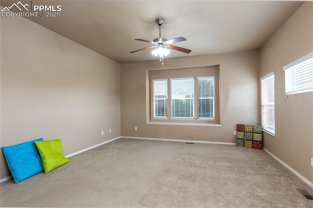 Image 18 of 46: Empty room featuring a ceiling fan and carpet flooring