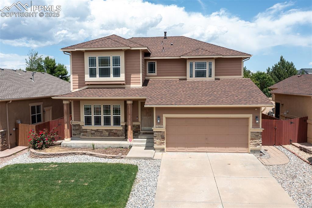 Image 2 of 46: Prairie-style house with driveway, an attached garage, roof with shingles, 