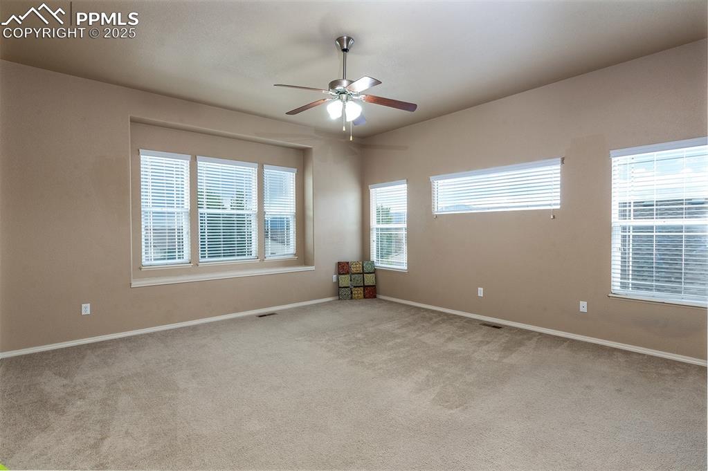 Image 21 of 46: Spare room with light colored carpet and ceiling fan
