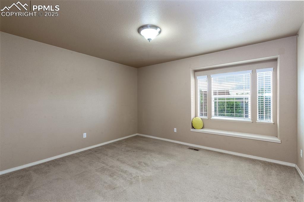 Image 22 of 46: Empty room with carpet flooring