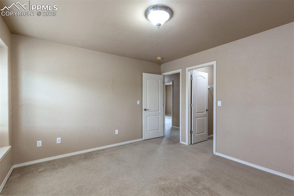 Image 26 of 46: Spare room featuring light carpet and a smoke detector