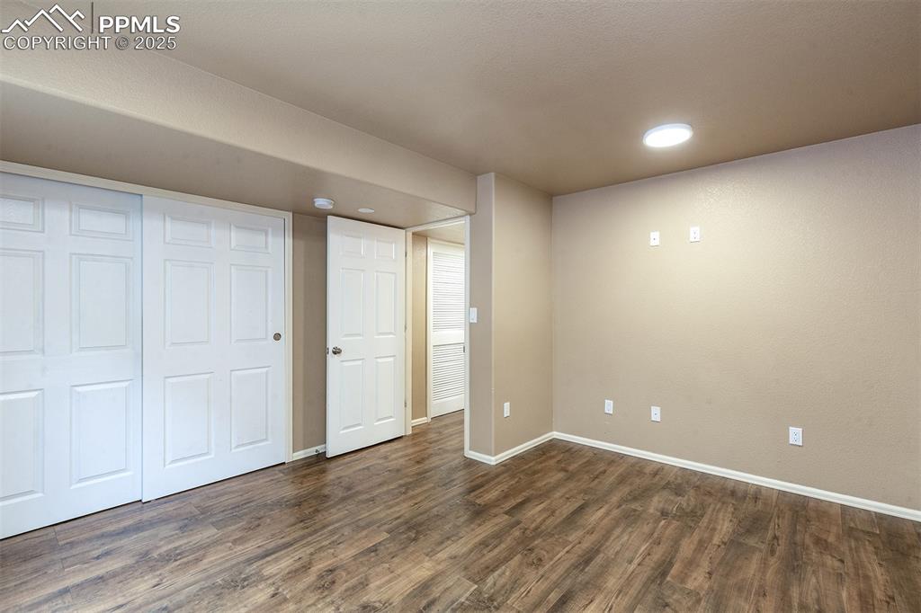 Image 28 of 46: Unfurnished bedroom featuring dark wood-style flooring, recessed lighting, 