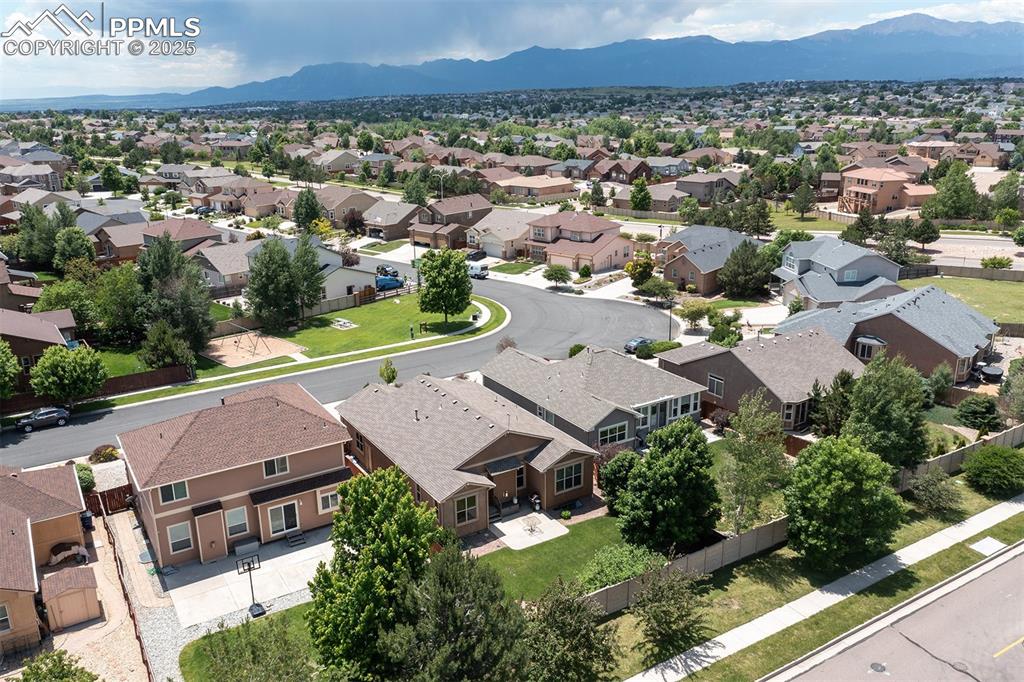 Image 40 of 46: Aerial perspective of suburban area with a mountain backdrop