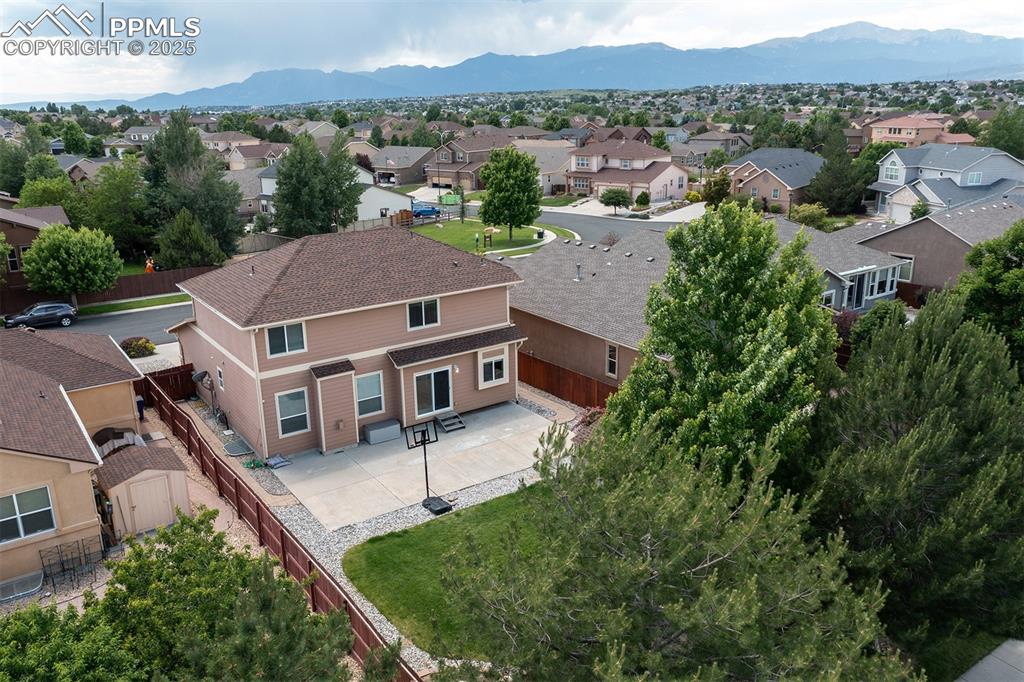 Image 43 of 46: Aerial view of residential area featuring mountains