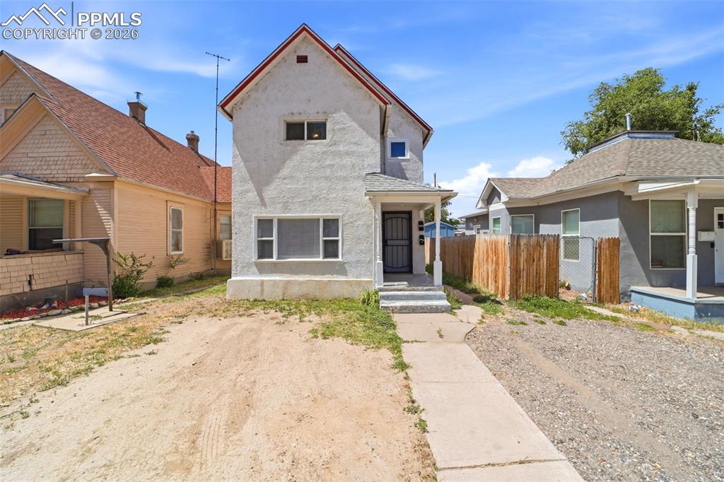 Image 1 of 50: Two-story property featuring a stucco exterior with a red trim roof