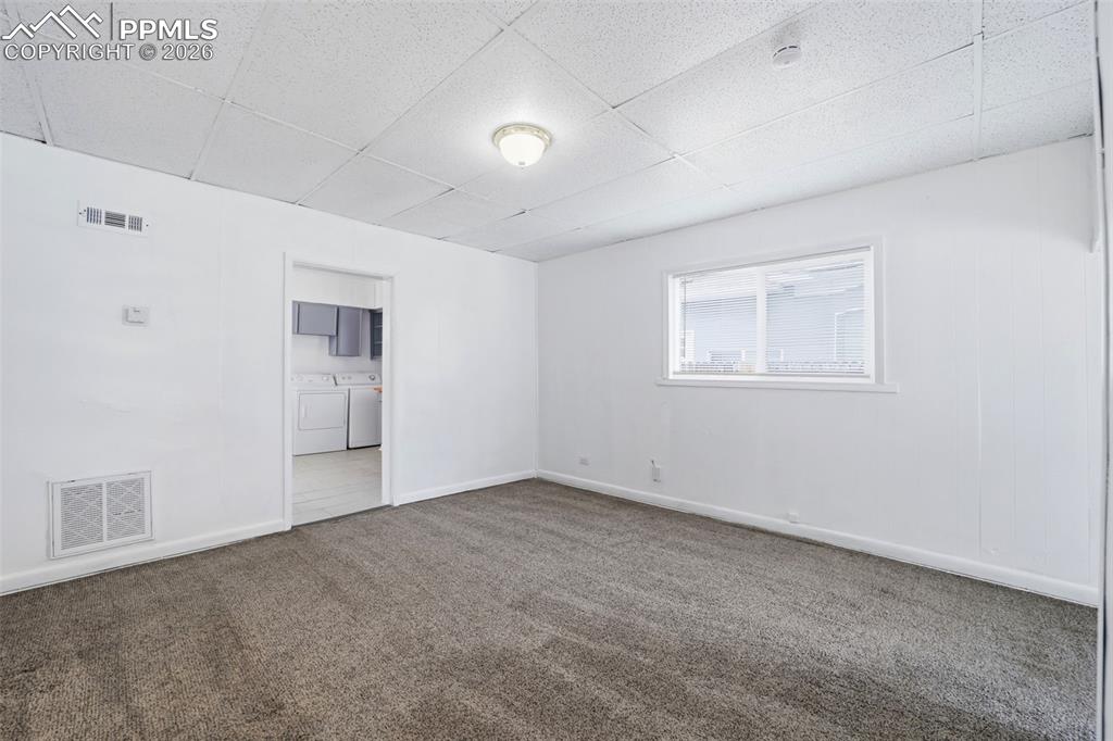 Image 28 of 50: Carpeted room featuring a white ceiling with recessed lighting, a window, a