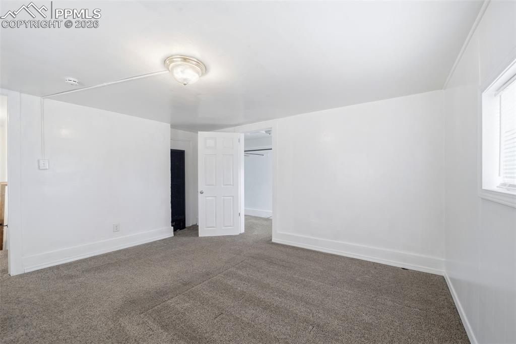 Image 33 of 50: Spacious room featuring neutral carpeting, white painted walls, a flush-mou
