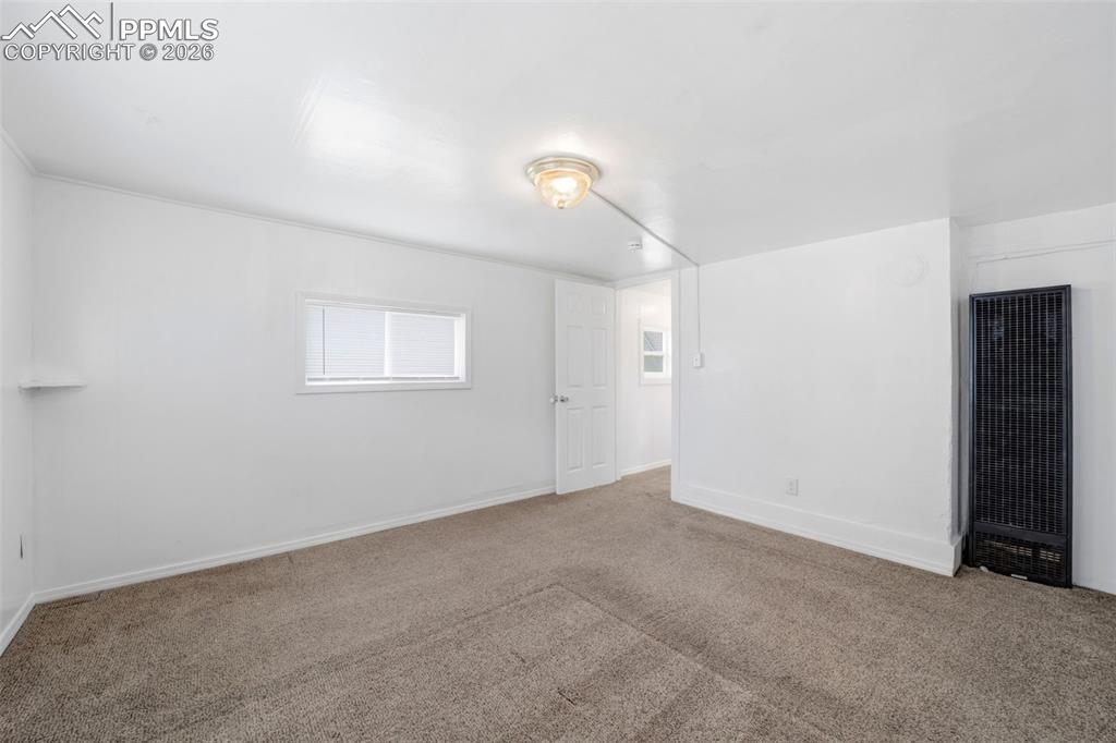 Image 34 of 50: Neutral toned carpet flooring and bright white walls