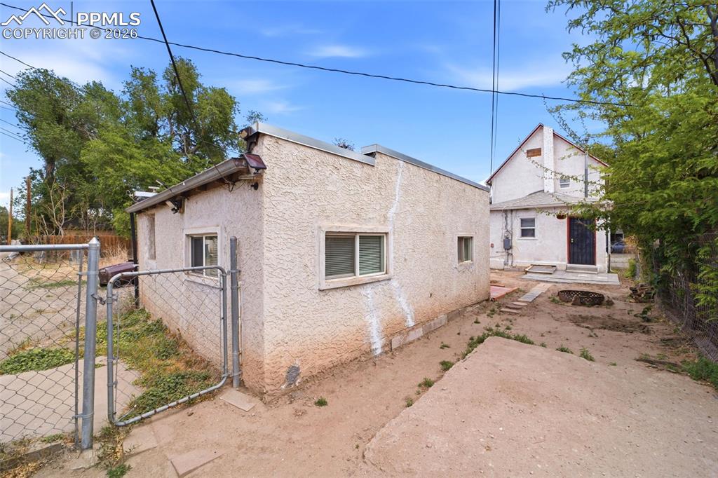 Image 43 of 50: Detached accessory building with stucco exterior