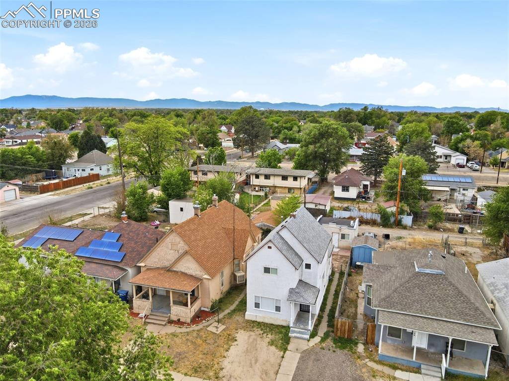 Image 47 of 50: Aerial perspective showcasing multiple properties with shingle roofs and es